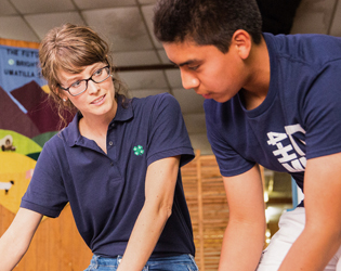 Girl and boy working on a 4-H project